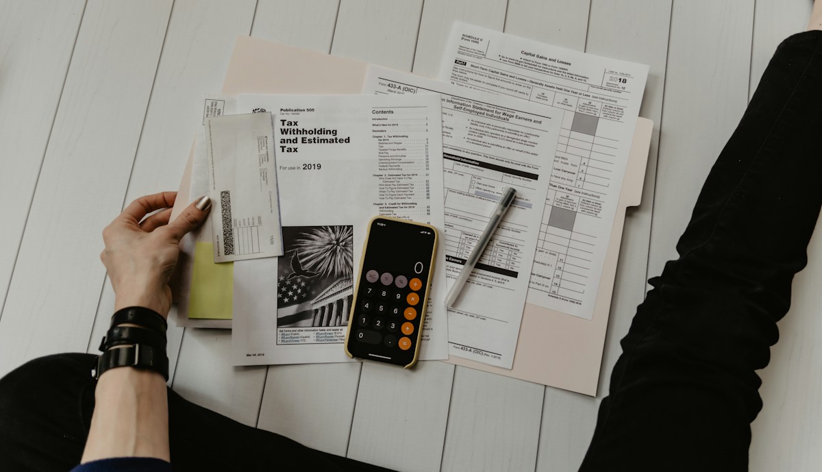 Calculator and financial documents on a desk for household budgeting