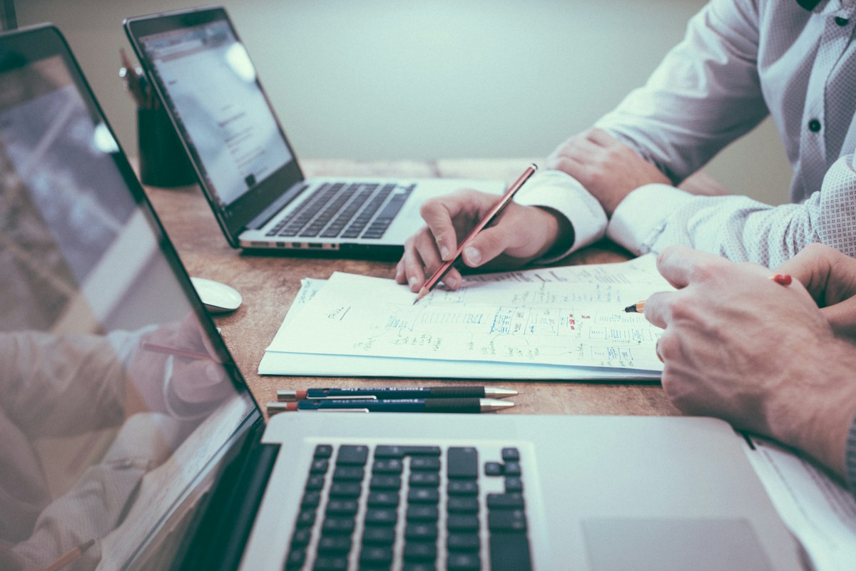 Professional reviewing planning documents at a meeting table